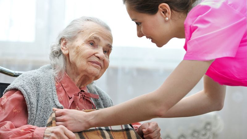 A hospice nurse cares for an elderly person.